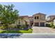 Two-story house with tan siding, landscaped lawn, and a three-car garage at 4063 Villa Rafael Dr, Las Vegas, NV 89141