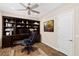 Home office with built-in shelving, desk, and comfortable chair at 4063 Villa Rafael Dr, Las Vegas, NV 89141