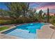 Relaxing pool with a tanning ledge and tranquil landscaping at 4063 Villa Rafael Dr, Las Vegas, NV 89141