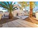 Large backyard with patio, gravel landscaping, and palm trees at 4116 W Delhi Ave, North Las Vegas, NV 89032