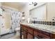 Bathroom with granite countertop vanity and shower/tub combo at 4116 W Delhi Ave, North Las Vegas, NV 89032