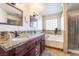 Double vanity bathroom with granite countertops and a soaking tub at 4116 W Delhi Ave, North Las Vegas, NV 89032