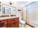 Clean bathroom with granite vanity, updated shower, and decorative curtain at 4116 W Delhi Ave, North Las Vegas, NV 89032