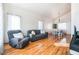 Living room with hardwood floors, comfy seating, and dining area at 4116 W Delhi Ave, North Las Vegas, NV 89032