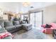 Open living room with a view of the kitchen and sliding glass doors at 4116 W Delhi Ave, North Las Vegas, NV 89032