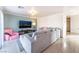 Spacious living room featuring a large sectional sofa and a wall-mounted TV at 4116 W Delhi Ave, North Las Vegas, NV 89032