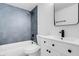 Bathroom with tub, shower, gray tile and white vanity at 4182 Mississippi Ave, Las Vegas, NV 89103