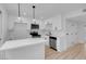 Modern white kitchen with stainless steel appliances and an island at 4182 Mississippi Ave, Las Vegas, NV 89103