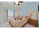 Bedroom featuring an accent wall, window, and nightstands at 422 Blush Creek Pl, Las Vegas, NV 89144