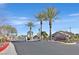 Community entrance featuring a gate and palm trees at 422 Blush Creek Pl, Las Vegas, NV 89144