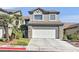 Two-story house with attached garage and palm trees at 422 Blush Creek Pl, Las Vegas, NV 89144