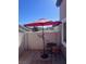 Private patio with an umbrella, seating, and privacy wall at 422 Blush Creek Pl, Las Vegas, NV 89144