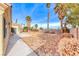 Landscaped backyard with grassy area and palm trees at 4416 Inez Dr, Las Vegas, NV 89130