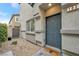 Townhome entrance with gray door and small front yard at 4655 Fuchsia Nights Ave # 103, North Las Vegas, NV 89084