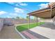 Covered patio overlooks a grassy backyard enclosed by a block wall at 5423 Arturo Ct, Las Vegas, NV 89120