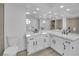 Bright bathroom boasts a corner double vanity and modern fixtures at 5423 Arturo Ct, Las Vegas, NV 89120