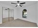 Well-lit bedroom featuring a ceiling fan and arched window at 5423 Arturo Ct, Las Vegas, NV 89120