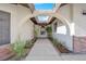 Covered walkway with arched entryway and nicely landscaped pathway at 5423 Arturo Ct, Las Vegas, NV 89120