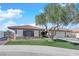 Single story home with a two-car garage and nicely landscaped front yard at 5423 Arturo Ct, Las Vegas, NV 89120