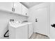 Bright laundry room with washer, dryer, and white cabinets at 5423 Arturo Ct, Las Vegas, NV 89120