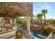 Spacious covered patio with seating area and views of the pool and landscape at 609 China Doll Pl, Henderson, NV 89012