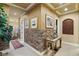 Stunning hallway with brick feature wall and ornate console table at 609 China Doll Pl, Henderson, NV 89012