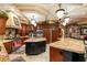 Gourmet kitchen with island, granite counters, and custom cabinetry at 609 China Doll Pl, Henderson, NV 89012