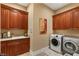 Bright laundry room with ample cabinetry and washer/dryer at 609 China Doll Pl, Henderson, NV 89012