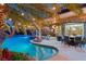 Luxury pool with spa, seating, and string lights at 609 China Doll Pl, Henderson, NV 89012