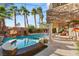 Resort-style pool with spa and waterfall feature, surrounded by a spacious patio at 609 China Doll Pl, Henderson, NV 89012