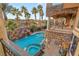 Stunning bird's-eye view of a luxurious pool and spa with surrounding decks at 609 China Doll Pl, Henderson, NV 89012