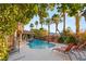 Relaxing pool and patio area with lounge chairs and stunning mountain views at 609 China Doll Pl, Henderson, NV 89012