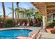 Inviting pool area with lounge chairs, a gazebo, and a spiral staircase at 609 China Doll Pl, Henderson, NV 89012