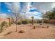 Landscaped backyard with gravel and drought-tolerant plants at 6504 Birdcall St, North Las Vegas, NV 89084