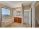 Bathroom with soaking tub, shower, and double vanity at 6504 Birdcall St, North Las Vegas, NV 89084