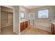 Main bathroom with double vanity, shower, and tub at 6504 Birdcall St, North Las Vegas, NV 89084