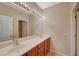 Bathroom boasts double sinks and wood cabinets at 6504 Birdcall St, North Las Vegas, NV 89084