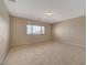 Bright bedroom featuring a large window and carpet at 6504 Birdcall St, North Las Vegas, NV 89084