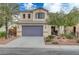 Two-story house with purple garage door and landscaping at 6504 Birdcall St, North Las Vegas, NV 89084