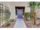 Front entry with purple door and landscaped walkway at 6504 Birdcall St, North Las Vegas, NV 89084