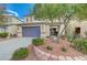 Two-story house with attached garage and landscaping at 6504 Birdcall St, North Las Vegas, NV 89084