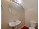 Small half bathroom with pedestal sink and toilet at 6504 Birdcall St, North Las Vegas, NV 89084