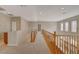 Upstairs hallway with wood railing and carpet at 6504 Birdcall St, North Las Vegas, NV 89084