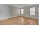 Bright bedroom with light gray walls and wood-look flooring at 6536 Elk Creek Ln, Las Vegas, NV 89156