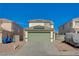 Two-story house with a green garage door and a landscaped front yard at 6536 Elk Creek Ln, Las Vegas, NV 89156