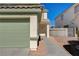 Green garage door and walkway to the home's entrance at 6536 Elk Creek Ln, Las Vegas, NV 89156