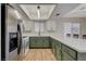 Updated kitchen featuring green cabinets and stainless steel fridge at 6536 Elk Creek Ln, Las Vegas, NV 89156