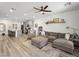 Open concept living room with gray sectional sofa and kitchen at 686 Last Dance Pl, Henderson, NV 89011