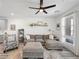 Living room with gray sectional sofa and ceiling fan at 686 Last Dance Pl, Henderson, NV 89011