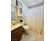 Cozy bathroom with white subway tiled walls and a patterned shower curtain at 7329 Restful Springs Ct, Las Vegas, NV 89128